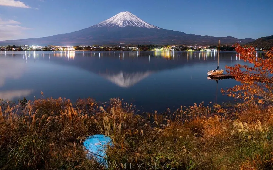 Mount Fuji reflected in a still lake at dawn
